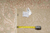Load image into Gallery viewer, A beige and cream patterned area rug with fringe, shown with a yellow tape measure and price tags on a matching rug surface.