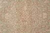 Load image into Gallery viewer, A close-up of a textured fabric or rug featuring an ornate, symmetrical floral and vine pattern in a dusty rose or terracotta color over a muted sage green background.
