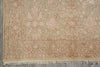 Load image into Gallery viewer, Close-up of an ornate area rug showing its detailed floral pattern and fringed edge, in muted beige and dusty rose tones.