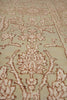 Load image into Gallery viewer, Close-up of a traditional patterned area rug with an ornate floral and vine design in beige and light brown tones.