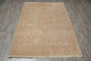 Load image into Gallery viewer, A rectangular area rug with a traditional floral pattern in muted beige, pink, and light green tones, laid flat on a gray wood-look floor.