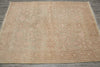 Load image into Gallery viewer, A square area rug with an intricate floral and medallion pattern in muted beige and dusty rose tones, laid flat on a gray wood floor.