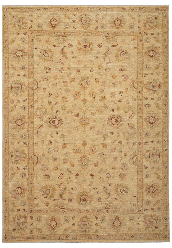 A traditional area rug with an intricate floral and geometric pattern in warm beige, tan, and muted brown tones, shown flat against a white background.