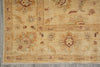 Load image into Gallery viewer, A close-up of a traditional oriental rug with a warm beige base, featuring faded floral motifs and geometric borders in muted brown, green, and rust tones.