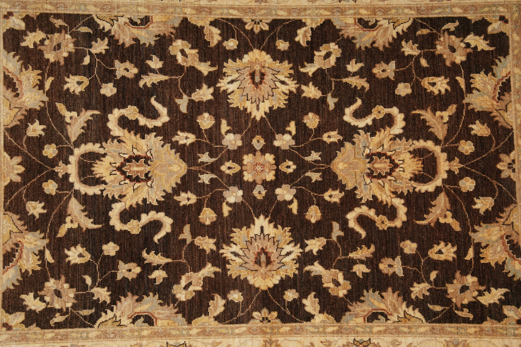 An ornate traditional area rug featuring a dark brown background with a beige and tan floral and vine pattern and a matching border.