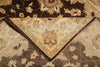 Load image into Gallery viewer, A close-up of a traditional oriental-style rug with a folded corner revealing its cream and brown patterned underside, set against a matching dark brown floral rug.