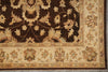 Load image into Gallery viewer, Close-up of an ornate area rug showing a dark brown central field with cream floral motifs and a beige border with floral details.