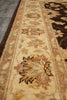 Load image into Gallery viewer, A close-up view of a traditional area rug with a beige center field, featuring floral motifs in brown, gold, and muted blue-gray, bordered by dark brown sections.