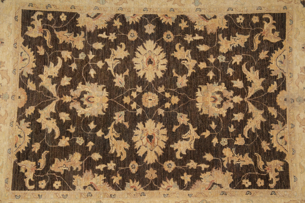 An antique oriental rug with a dark brown field and a beige floral pattern, framed by a wide beige border.