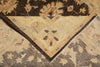 Load image into Gallery viewer, A close-up of an ornate patterned rug showing a folded corner that reveals a beige center with dark brown floral motifs and a dark brown border, layered over another section of the rug with a gray and beige floral design.