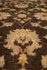 Load image into Gallery viewer, A close-up of a traditional patterned rug with a dark brown base and beige floral motifs, accented with subtle muted blue and red details.