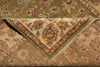 Load image into Gallery viewer, A folded vintage-style area rug with an intricate floral and medallion pattern in muted olive green, beige, and brown tones.