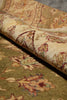 Load image into Gallery viewer, A close-up of a traditional patterned area rug with a rolled section showing its pile and design details. The rug features a warm beige and olive green base with floral motifs in muted red, blue, and yellow accents.