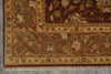 Load image into Gallery viewer, A close-up of an ornate area rug corner showing a dark brown field, beige and gold floral motifs, and a patterned border with fringe along the bottom edge.