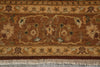 Load image into Gallery viewer, A close-up of an ornate area rug with a traditional floral pattern in shades of brown, beige, and muted green, featuring a fringed edge at the bottom.