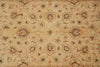 Load image into Gallery viewer, An antique floral patterned rug in beige with red, blue, and green accents, showing detailed woven texture and traditional motifs.