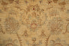 Load image into Gallery viewer, A close-up of a textured area rug featuring a traditional floral and botanical pattern in muted beige, tan, and dusty red tones.