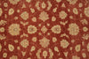 Load image into Gallery viewer, A close-up of a red area rug with a beige floral and vine pattern.