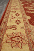 Load image into Gallery viewer, A close-up view of a traditional patterned area rug with a warm beige center, red and rust borders, and floral motifs.