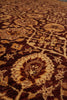 Load image into Gallery viewer, A close-up view of a traditional patterned area rug with intricate floral and geometric motifs in dark brown, rust red, beige, and cream.
