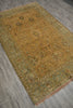 Load image into Gallery viewer, A rectangular area rug with a traditional floral pattern, featuring a mustard yellow center and a muted sage green border, laid out on a gray wood-look floor.