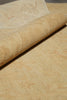 Load image into Gallery viewer, A close-up of a rolled beige fabric or textile laid over a matching flat surface, showing a soft woven texture and subtle tonal pattern.