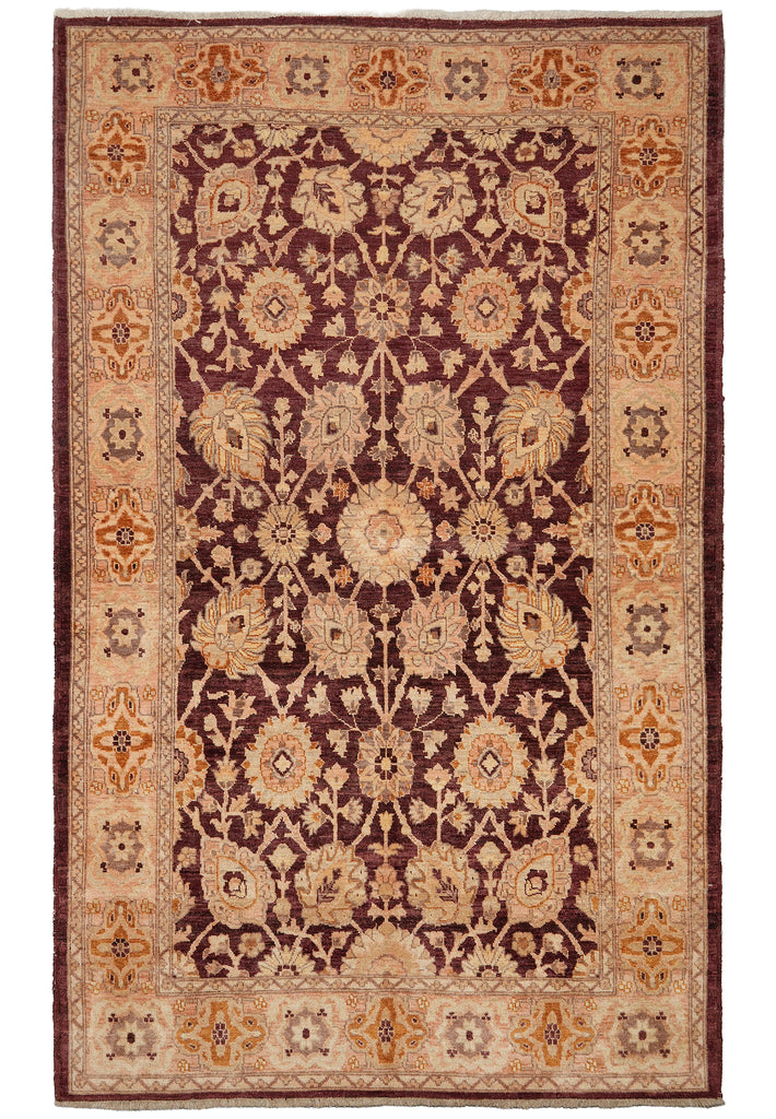 A rectangular traditional area rug with an intricate floral and medallion pattern, featuring a dark burgundy center, a beige inner border, and a rust-orange outer border.