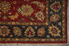 Load image into Gallery viewer, A close-up of an ornate area rug showing a deep red field with a dark charcoal-gray border and intricate floral motifs in beige, gold, and muted green.
