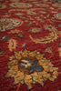 Load image into Gallery viewer, A close-up view of a traditional patterned area rug with a deep red background and ornate floral motifs in gold, green, and gray.