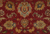 Load image into Gallery viewer, A close-up of a traditional patterned rug with a deep red background and ornate floral motifs in beige, blue, and muted green.