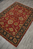 Load image into Gallery viewer, A traditional oriental area rug with a deep red field, ornate floral motifs, and dark borders, shown laid out on a gray wood-look floor.