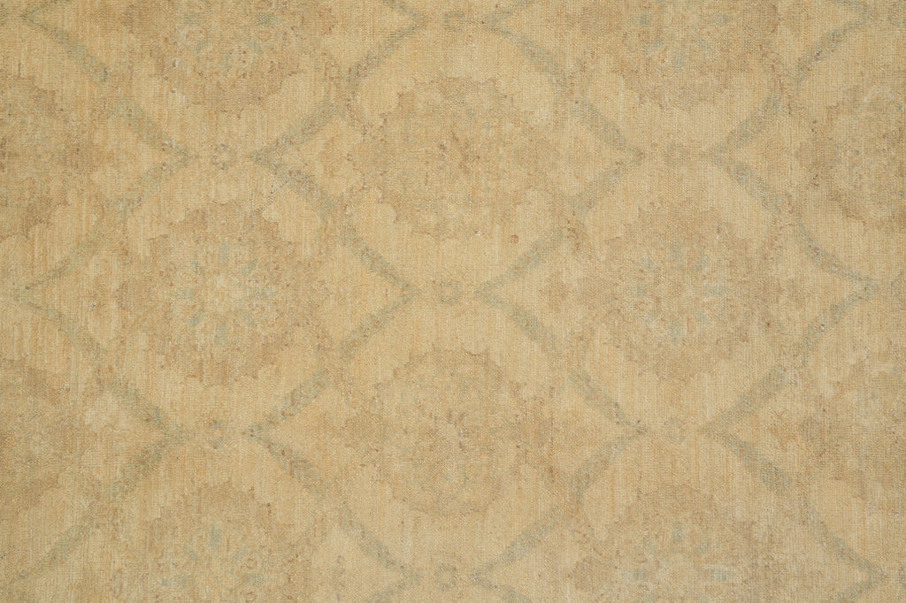 Beige textured fabric with a subtle distressed geometric lattice pattern in muted gray-green tones.
