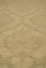Load image into Gallery viewer, A close-up view of a textured area rug with a faded geometric diamond pattern in warm beige and light tan tones.