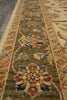 Load image into Gallery viewer, A close-up view of a traditional oriental area rug with a floral medallion pattern in olive green, beige, rust red, and navy blue.