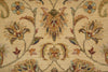 Load image into Gallery viewer, Close-up of a woven floral rug pattern on a warm beige background, featuring cream, tan, muted green, and brown botanical motifs.