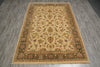 Load image into Gallery viewer, A rectangular traditional area rug with an ornate floral and vine pattern, laid out on a gray wood-look floor. The rug features a beige center field surrounded by olive green and rust-brown borders.