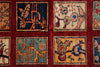 Load image into Gallery viewer, Close-up of a woven rug or textile with a deep red field and multiple square panels containing abstract and floral motifs in navy, beige, teal, and ochre.