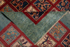 Load image into Gallery viewer, A close-up of a patterned area rug showing both the top and reverse sides. The top side features a geometric border with floral motifs in red, navy, and beige.