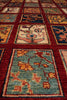 Load image into Gallery viewer, A close-up view of a traditional hand-knotted area rug with a grid pattern of square panels. The rug features a deep red border framing panels with floral and geometric motifs in muted shades of blue, green, beige, and orange.