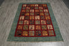 Load image into Gallery viewer, A rectangular area rug with a teal-green textured border and a central grid of small square panels in red, orange, beige, and navy, laid out on a gray wood-look floor.