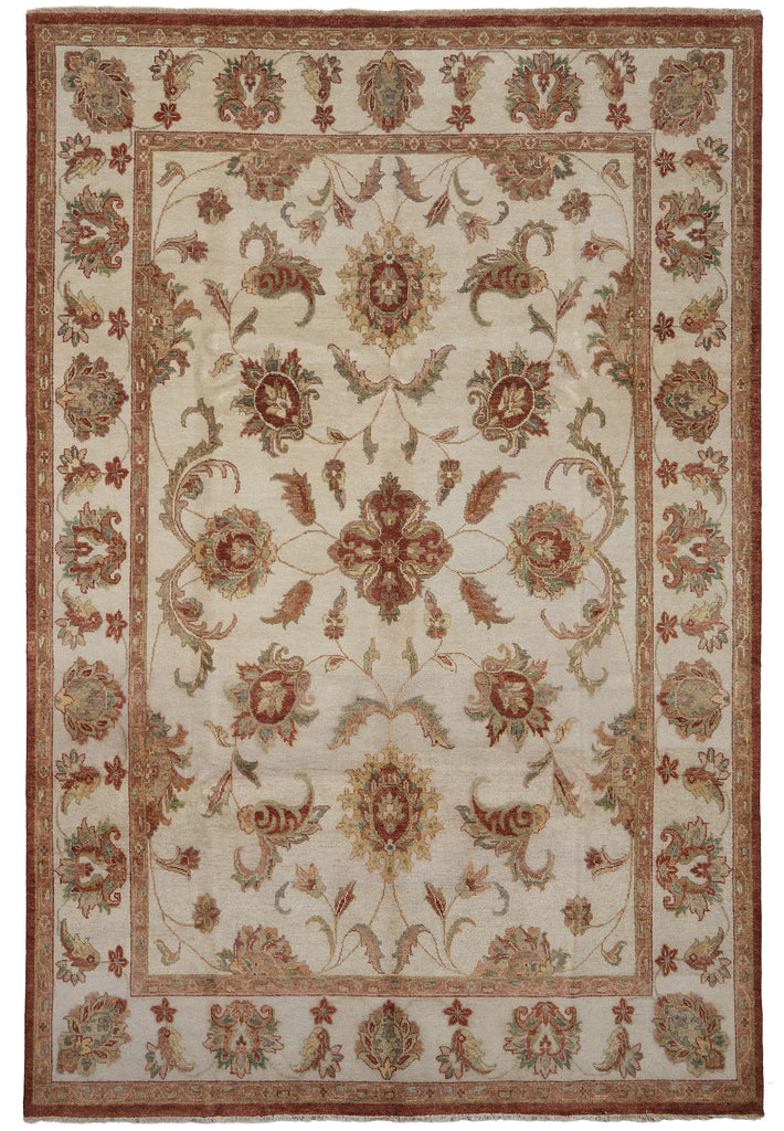An area rug with a traditional floral and ornamental pattern, featuring a cream center field, rust red borders, and muted green and gold accents.