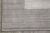 Load image into Gallery viewer, Close-up of a gray textured rug with a subtle geometric block pattern, laid on a gray wooden floor.