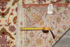 Load image into Gallery viewer, Back of the 6.7 x 10.3 Persian Tabriz rug being measured with a tape measure, showing the hand-woven oriental rug hang tag labeled PIX-21984