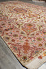 Load image into Gallery viewer, Corner detail of the 6.7 x 10.3 Persian Tabriz rug showing the ivory field, urn and floral motifs, and rose-pink border
