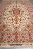Load image into Gallery viewer, 6.7 x 10.3 Persian Tabriz rug end detail with central medallion, pink floral border, and hand-knotted fringe with woven signature panel