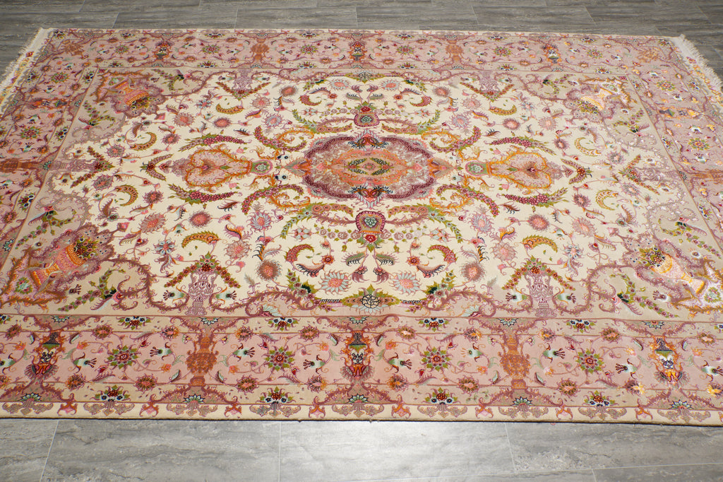 Wide angle view of the 6.7 x 10.3 Persian Tabriz rug on the floor, highlighting the medallion center and floral border in pink, beige, and orange