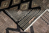 Load image into Gallery viewer, Close-up of a patterned rug with geometric designs.