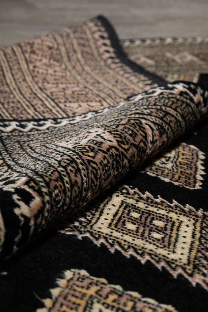 Close-up of patterned fabric with geometric designs in brown and beige.