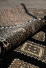 Load image into Gallery viewer, Close-up of patterned fabric with geometric designs in brown and beige.