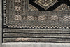 Load image into Gallery viewer, Close-up of a patterned rug with geometric designs on a gray floor.